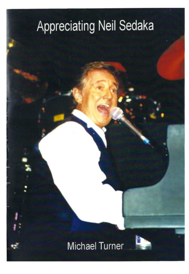 The cover of "Appreciating Neil Sedaka" including a photograph of Sedaka playing the piano and singing and the name of the author: Michael Turner